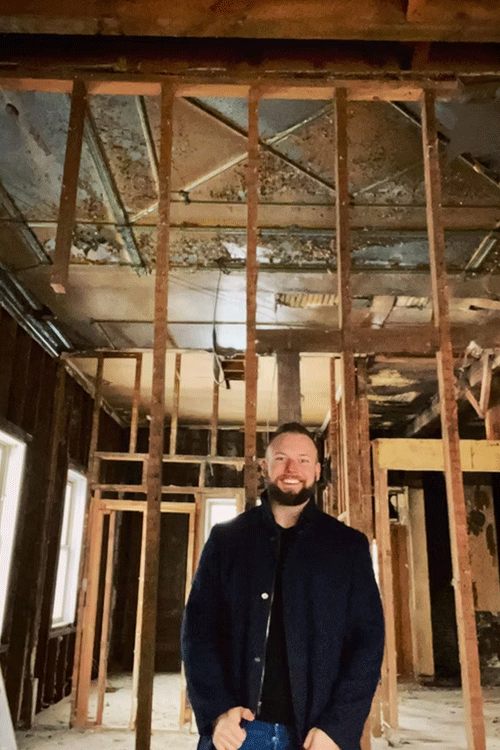 Ben Argall standing in building during renovation