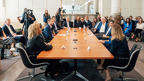 People sit around a boardroom table