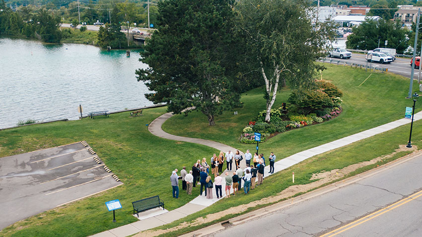 people stand on a sidewalk